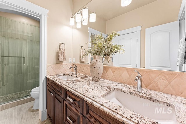 1452 S Hidden Island Pl, Eagle, ID 83616 - bathroom featuring double vanity, a stall shower, and tasteful backsplash