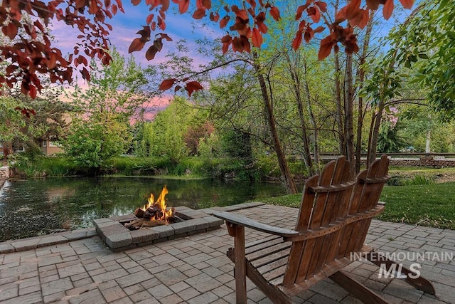 1452 S Hidden Island Pl, Eagle, ID 83616 - view of patio / terrace with an outdoor fire pit and a water view