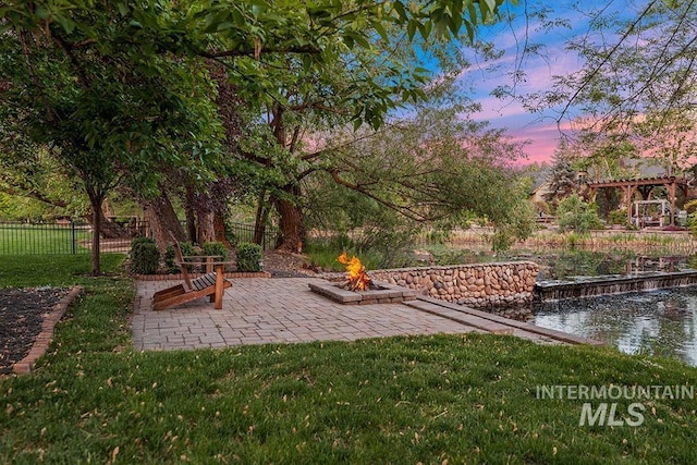 1452 S Hidden Island Pl, Eagle, ID 83616 - view of yard featuring an outdoor fire pit, a water view, and a patio area