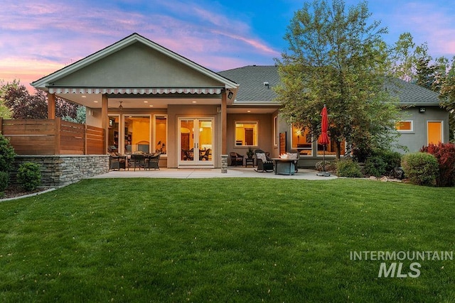 1452 S Hidden Island Pl, Eagle, ID 83616 - back of house at dusk featuring a patio area, stucco siding, and french doors