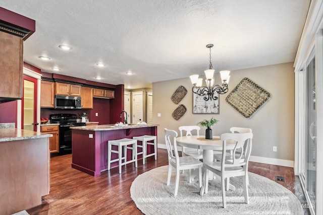 810 N Eagle Hills Way, Eagle, ID 83616 - dining space featuring a chandelier, baseboards, dark wood-style floors, and recessed lighting