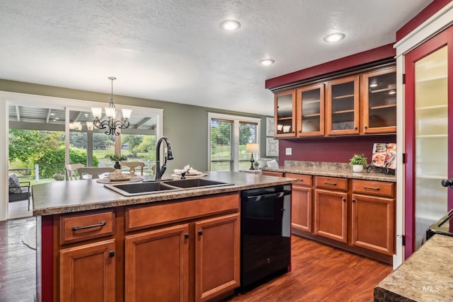 810 N Eagle Hills Way, Eagle, ID 83616 - kitchen with black dishwasher, a sink, dark wood finished floors, glass insert cabinets, and a chandelier