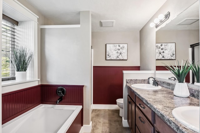 810 N Eagle Hills Way, Eagle, ID 83616 - full bathroom with healthy amount of natural light, double vanity, a garden tub, a wainscoted wall, and toilet