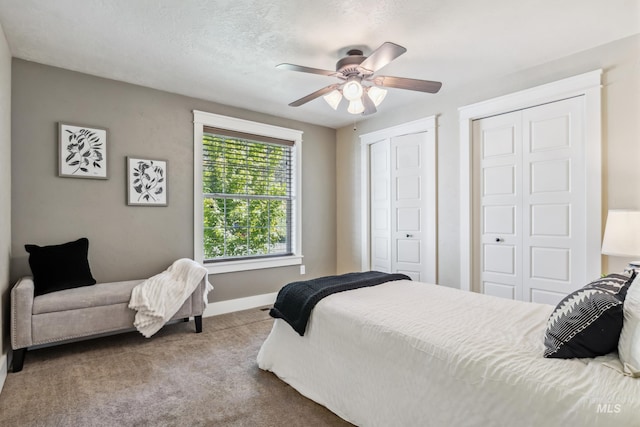 810 N Eagle Hills Way, Eagle, ID 83616 - bedroom with baseboards, two closets, carpet, and a ceiling fan