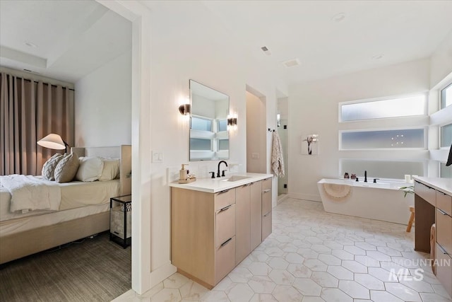 bathroom with a tub and vanity