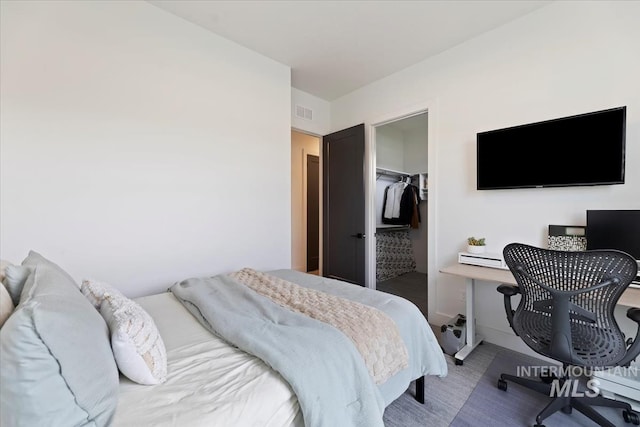 bedroom featuring a closet, carpet, and a spacious closet