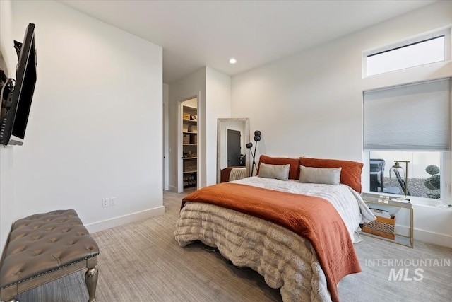 carpeted bedroom with a spacious closet