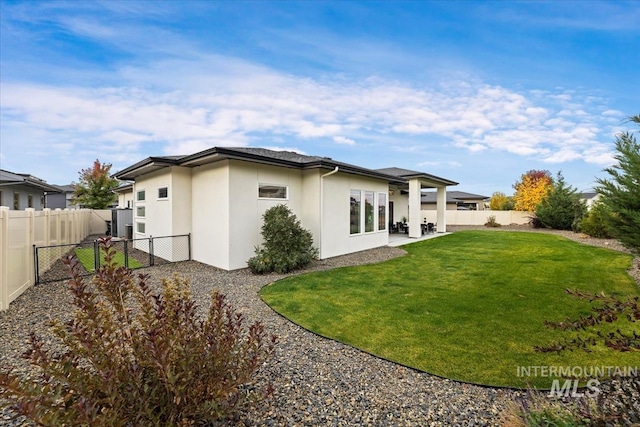 rear view of property with a lawn