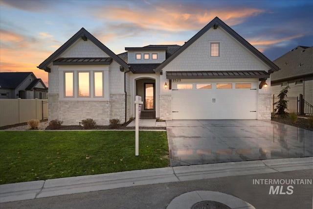 view of front of property featuring a garage and a yard