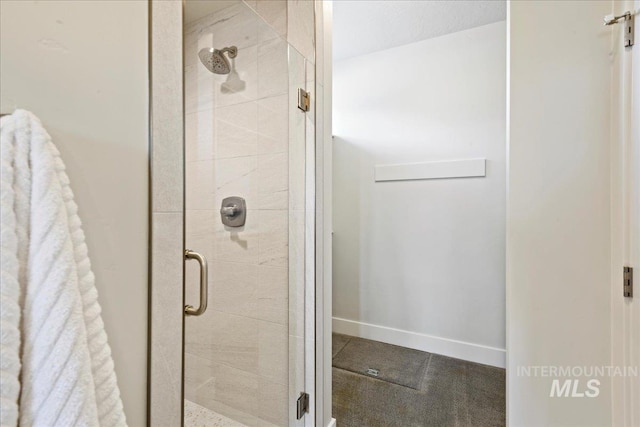 bathroom featuring a shower with door