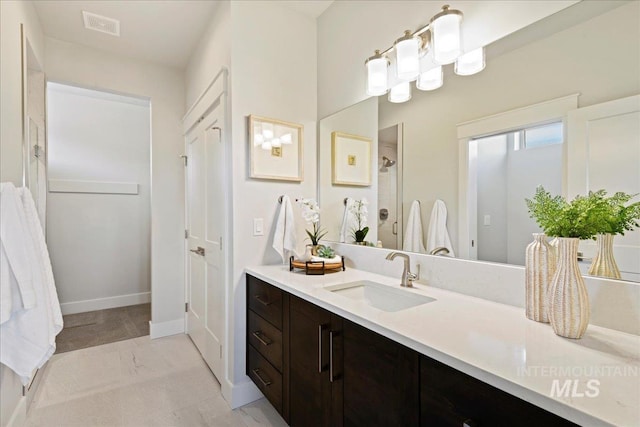 bathroom featuring vanity and a shower