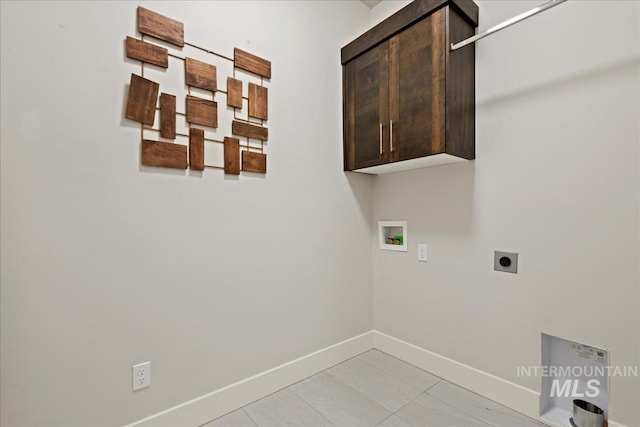 laundry room with washer hookup, electric dryer hookup, cabinets, and light tile patterned flooring