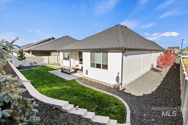 rear view of house featuring a patio area and a lawn