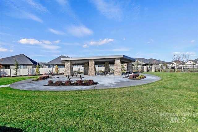 rear view of property featuring a yard and a patio area