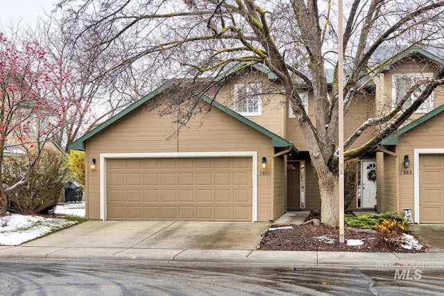 view of front of property with concrete driveway and an attached garage
