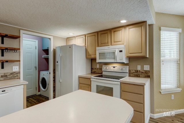 kitchen featuring light brown cabinetry, dark hardwood / wood-style flooring, white appliances, a textured ceiling, and washer / clothes dryer