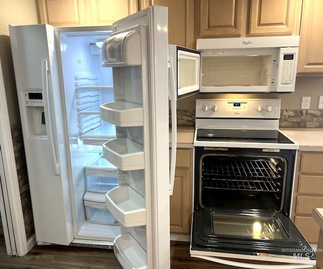 kitchen featuring light brown cabinets, dark wood-type flooring, and white appliances