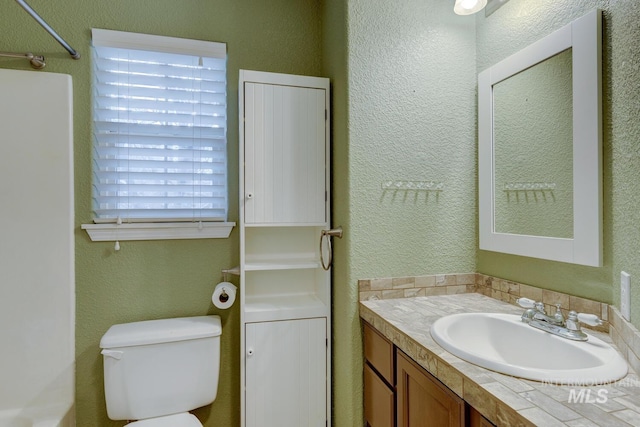 bathroom featuring vanity and toilet