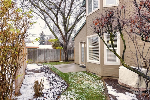 snowy yard featuring a patio