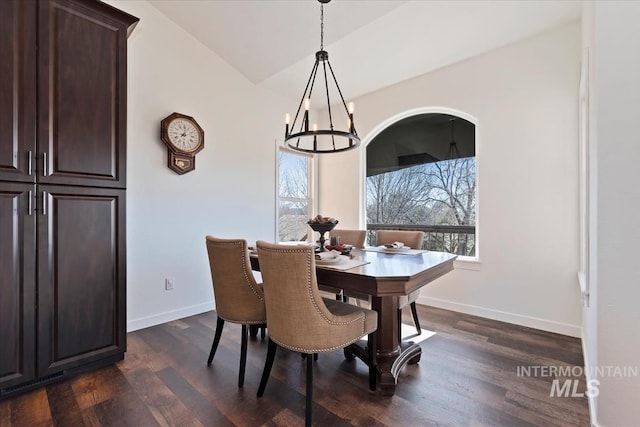 dining room with dark wood finished floors, baseboards, and a chandelier