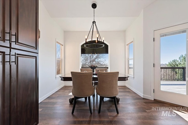 dining room with dark wood finished floors and baseboards