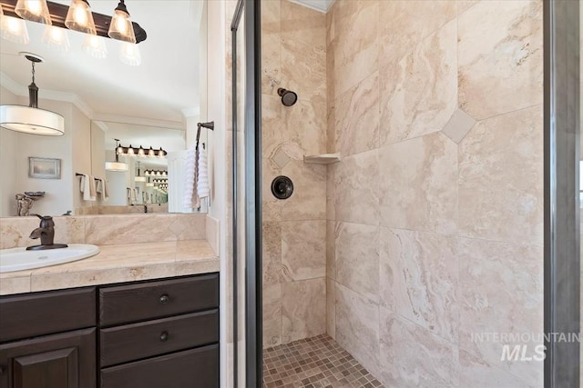 full bathroom with vanity, crown molding, and a shower stall