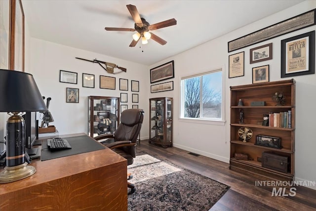 office featuring visible vents, baseboards, ceiling fan, and wood finished floors