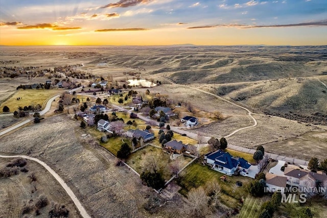 aerial view at dusk featuring a mountain view