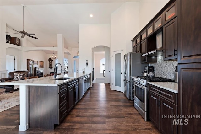 kitchen featuring a sink, stainless steel appliances, dark brown cabinets, and dark wood-style floors