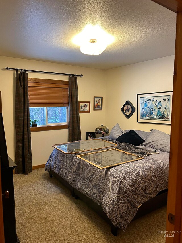 bedroom with carpet flooring and a textured ceiling