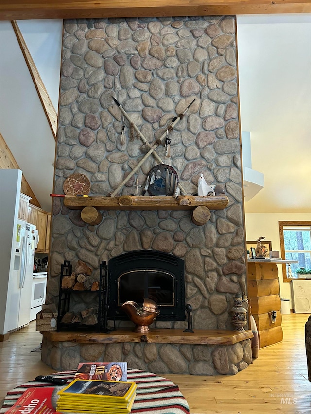 interior details featuring a fireplace, hardwood / wood-style floors, and white appliances