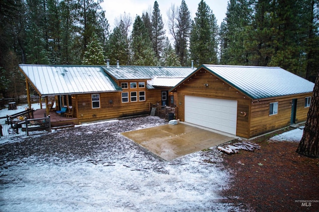 log-style house with a garage