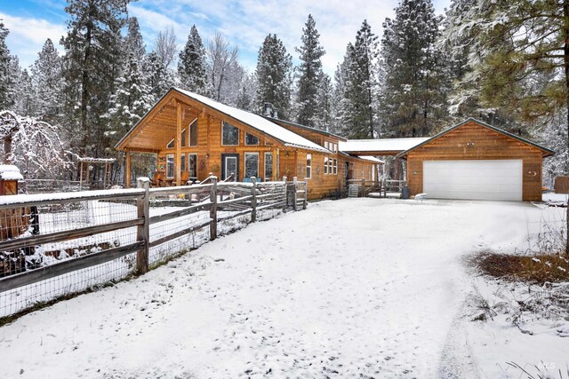 view of front of property featuring a garage and an outdoor structure