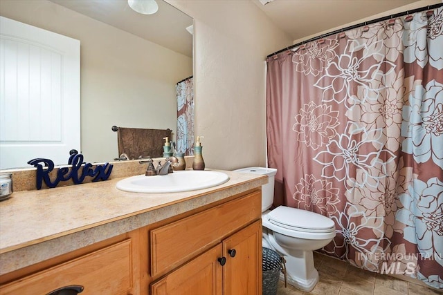 bathroom with toilet and vanity