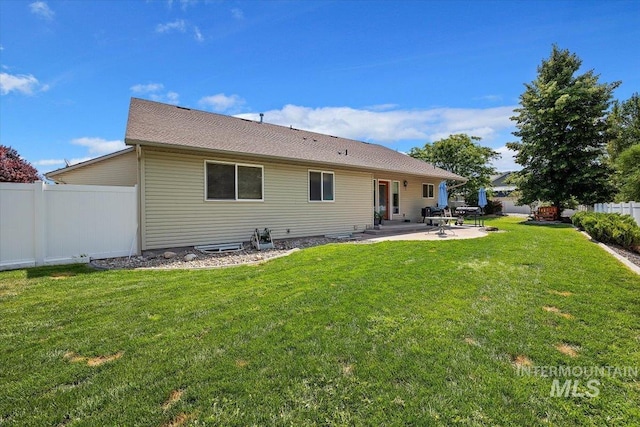 back of house with a yard and a patio area