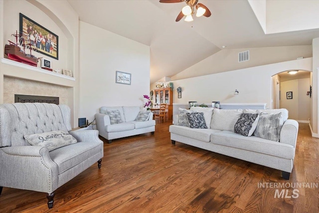 living room featuring ceiling fan, dark wood-type flooring, and lofted ceiling