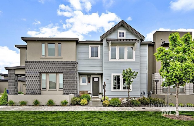 view of front of property with stucco siding and a front yard