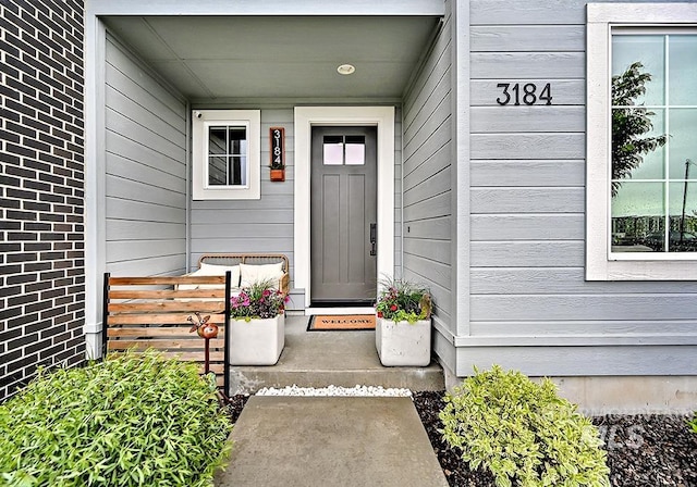 entrance to property featuring brick siding