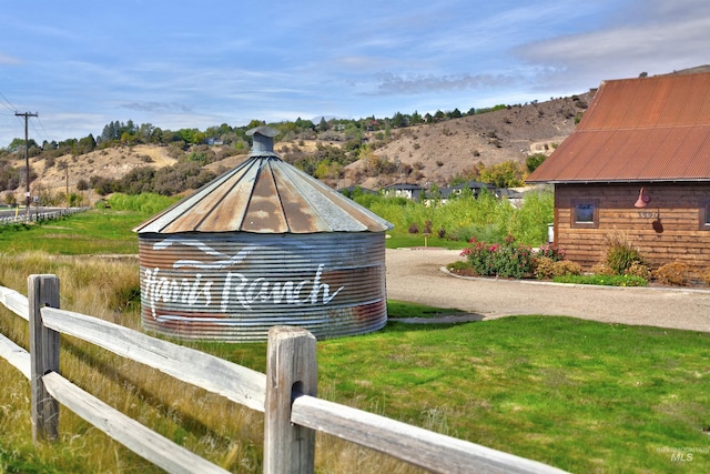 view of side of home featuring fence