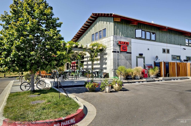 view of building exterior with uncovered parking
