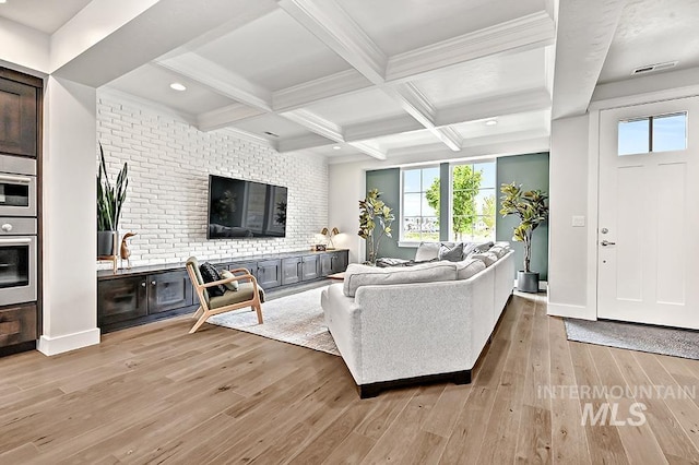 living area featuring light wood finished floors, recessed lighting, beamed ceiling, visible vents, and coffered ceiling