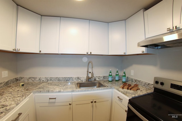 kitchen featuring white cabinets, sink, light stone counters, and electric range oven