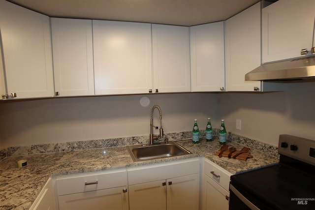 kitchen with sink, electric range, and white cabinetry