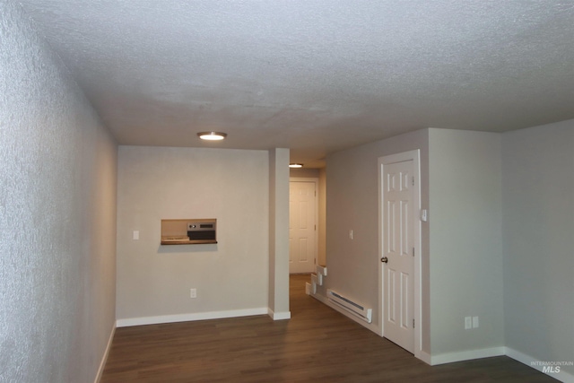 unfurnished room featuring a baseboard radiator, dark wood-type flooring, and a textured ceiling