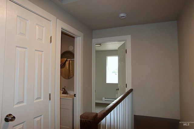 corridor with a baseboard heating unit