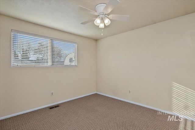 carpeted spare room with ceiling fan