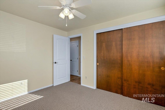 unfurnished bedroom featuring ceiling fan, carpet floors, and a closet