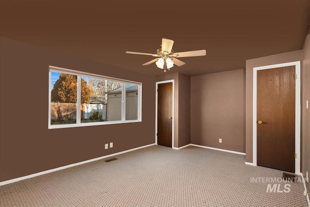 unfurnished bedroom featuring carpet floors and ceiling fan