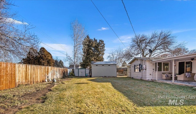 view of yard with a patio area and a storage unit