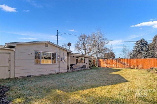 rear view of house with a yard